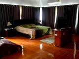 Large room with king size bed and a futon